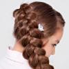 Weaving a French braid in reverse Malvinka from hair with a bow